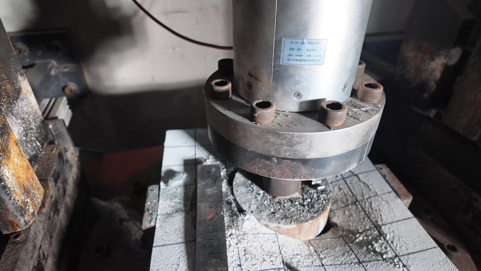 Close view of compression testing equipment and specimen