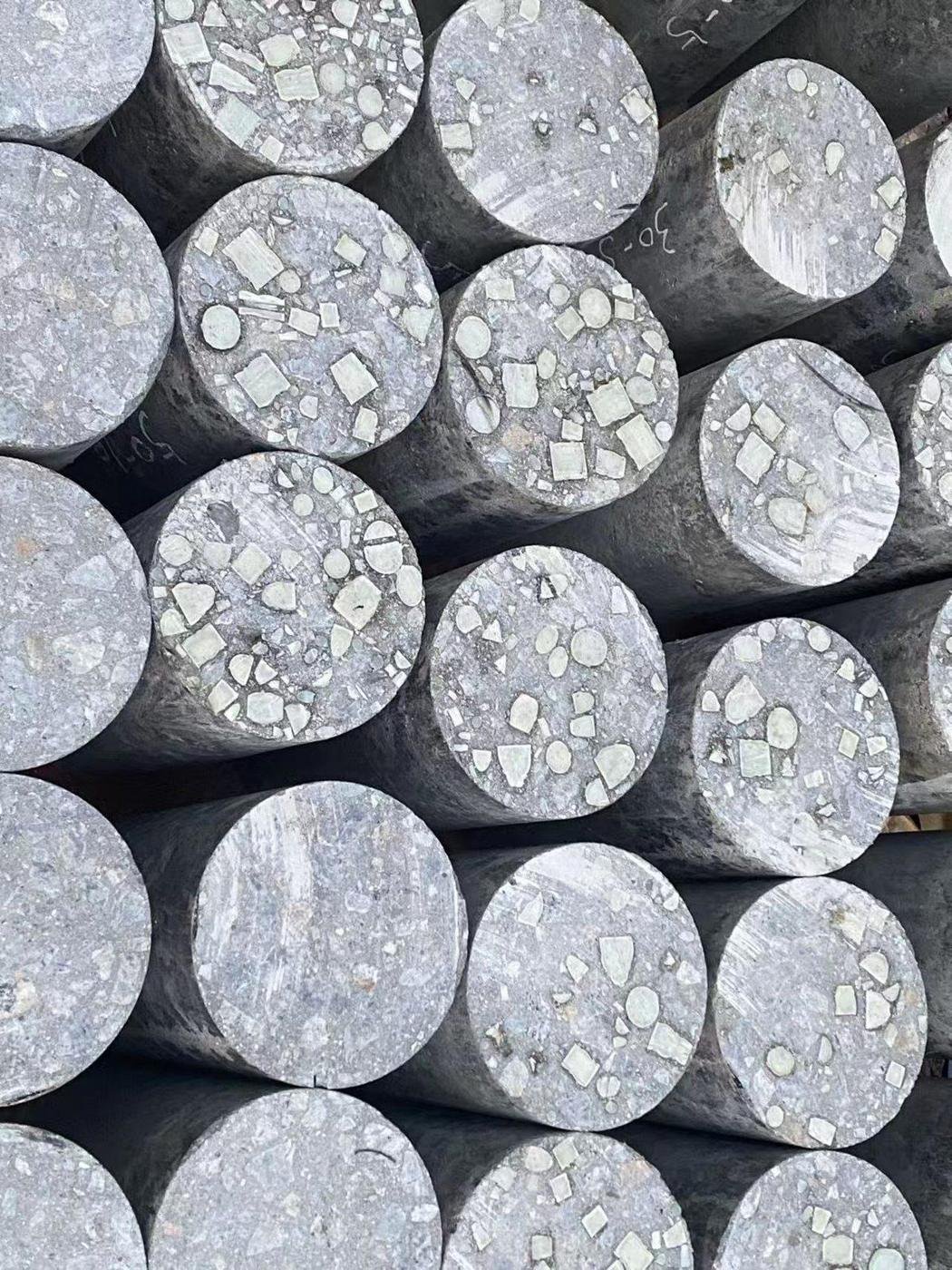Cylindrical core samples showing exposed aggregate distribution in recycled material