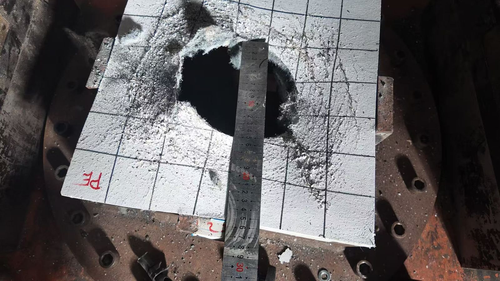 Perforated specimen measured with a steel ruler after drilling or loading