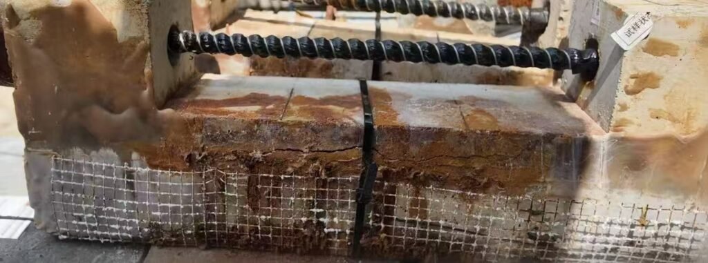 Close-up view of a CFRP-strengthened concrete beam showing surface deterioration after aggressive exposure.
